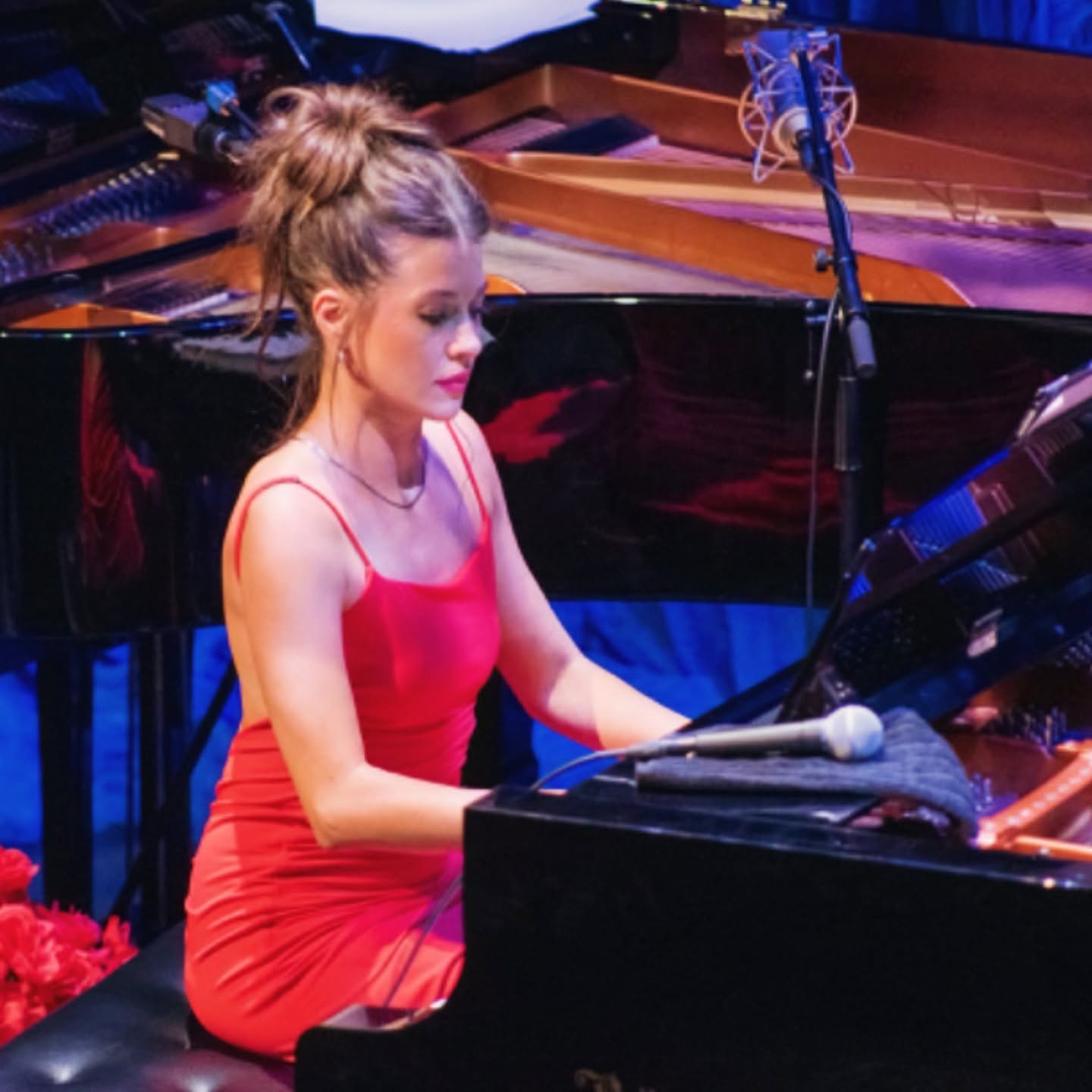 Andrea Johnson playing a grand piano.