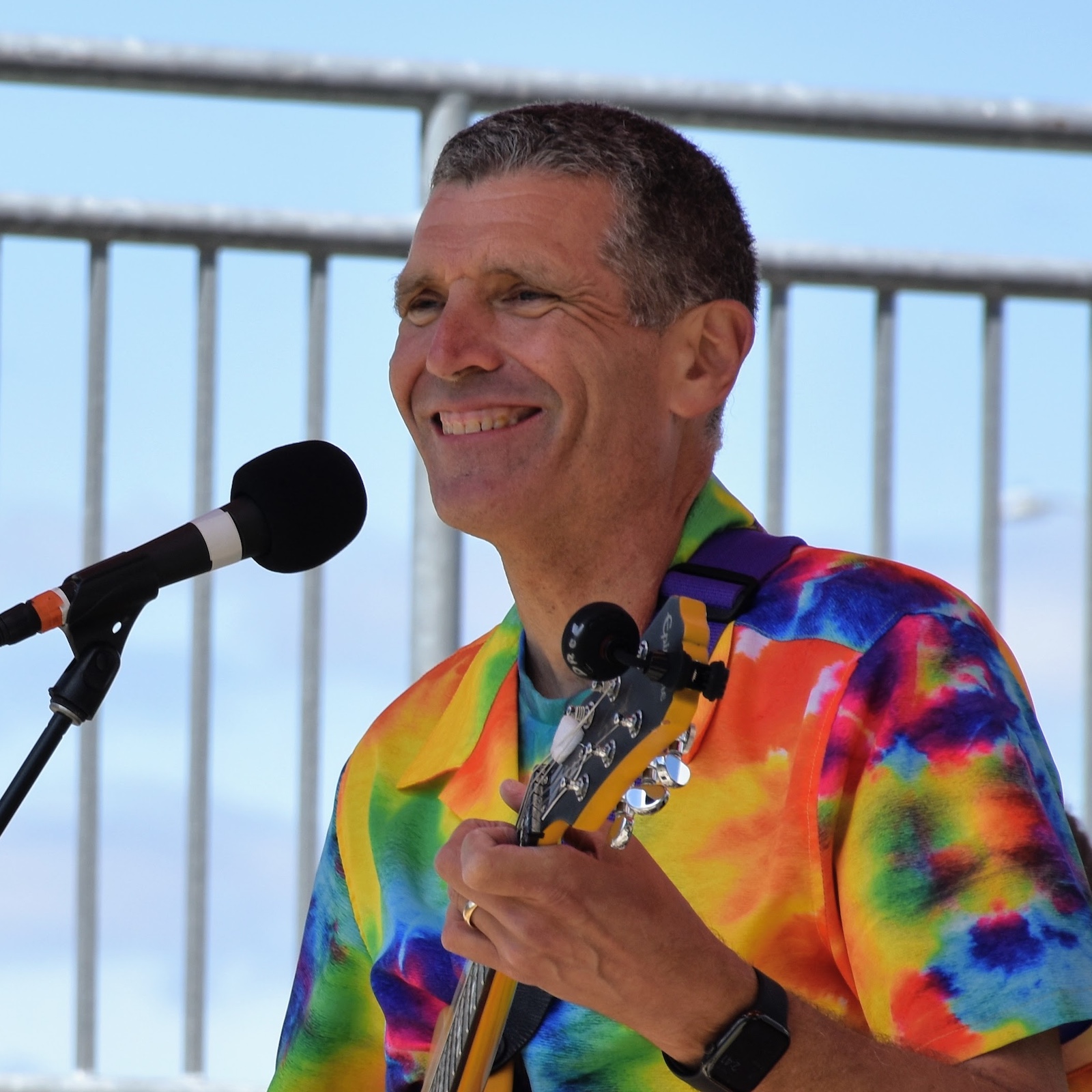 Kevin Droe playing electric guitar and singing into microphone