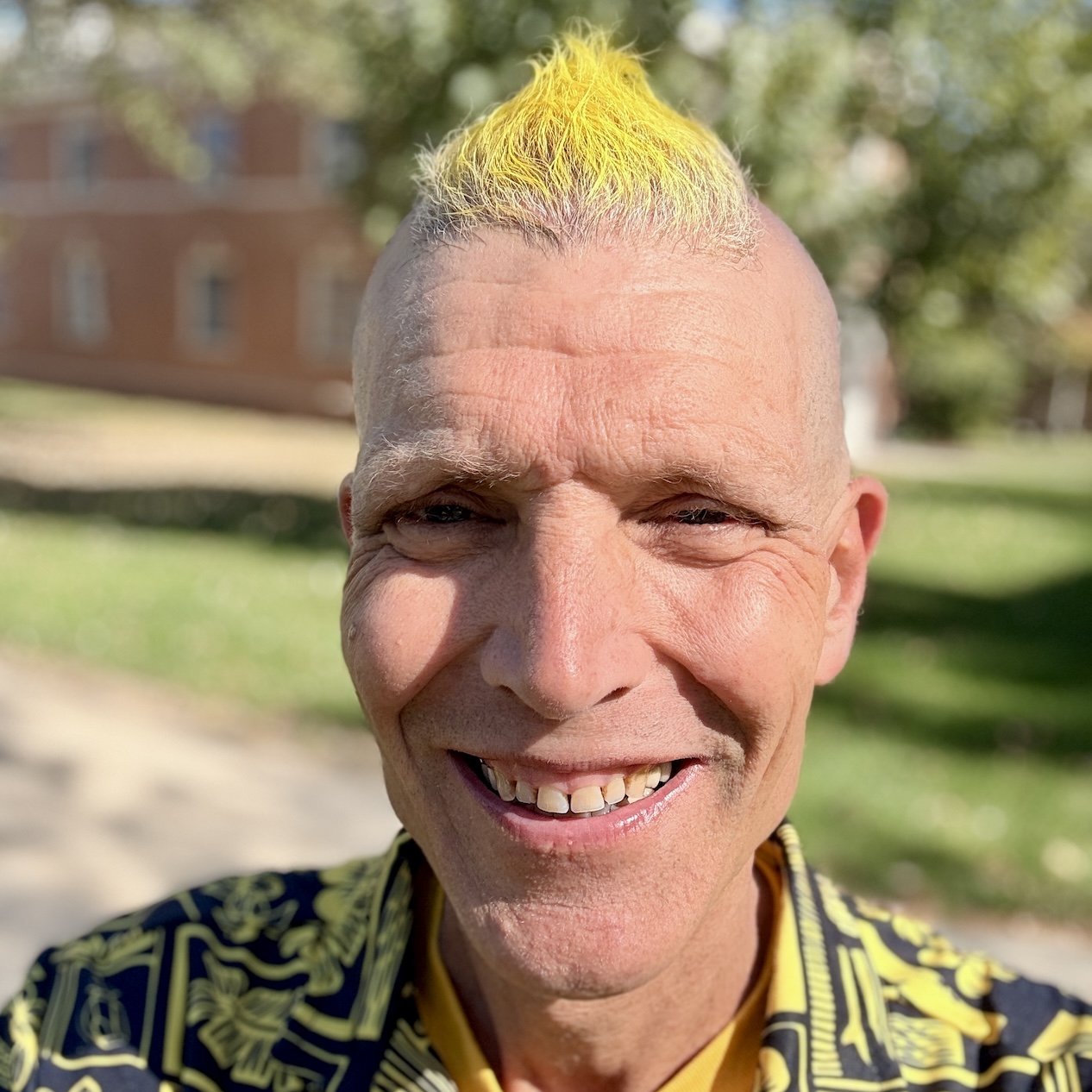 Headshot of Kevin Droe with gold Mohawk