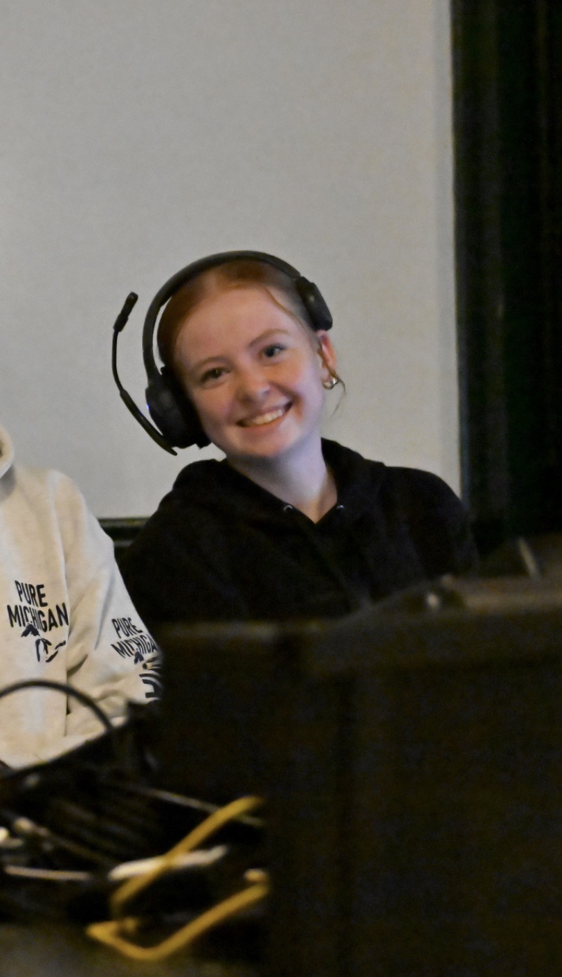 Nora Lahart sitting behind a keyboard with headphones on.
