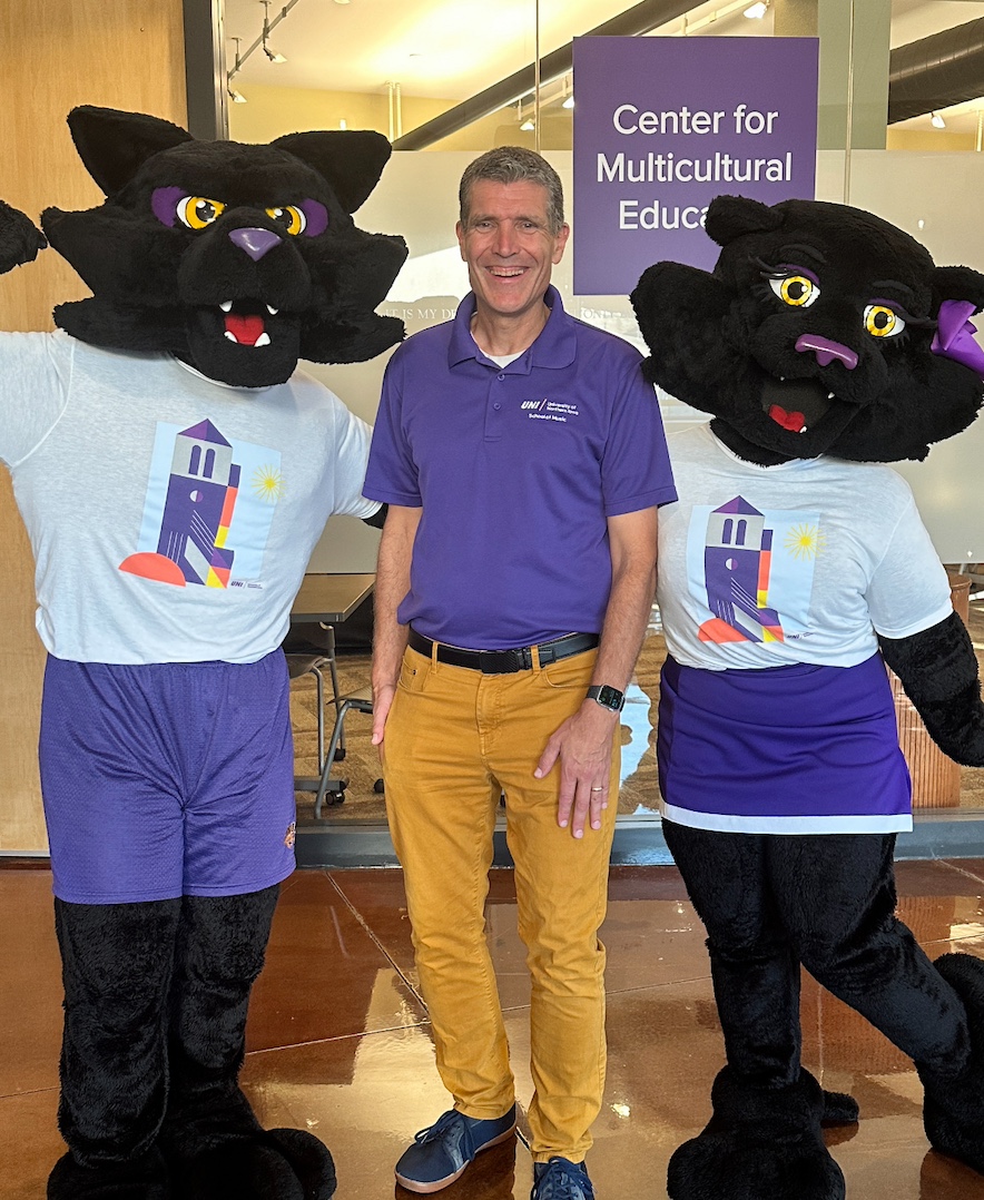 Kevin Droe standing with TC and TK, the UNI mascots