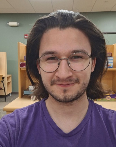 JD Deninger wearing glasses and blue shirt