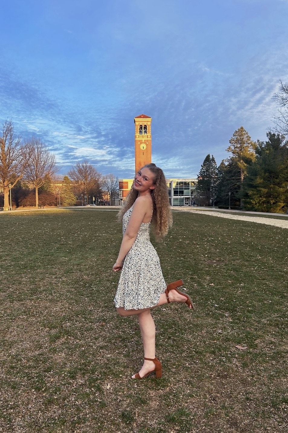 Zoe Meyer standing in front of the carillon on UNI campus