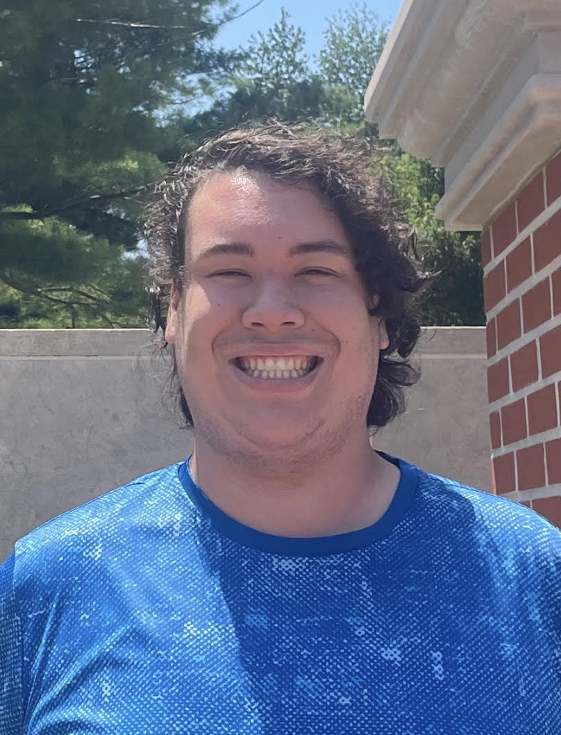 Jonathan Grorud wearing a blue shirt and smiling at the camera