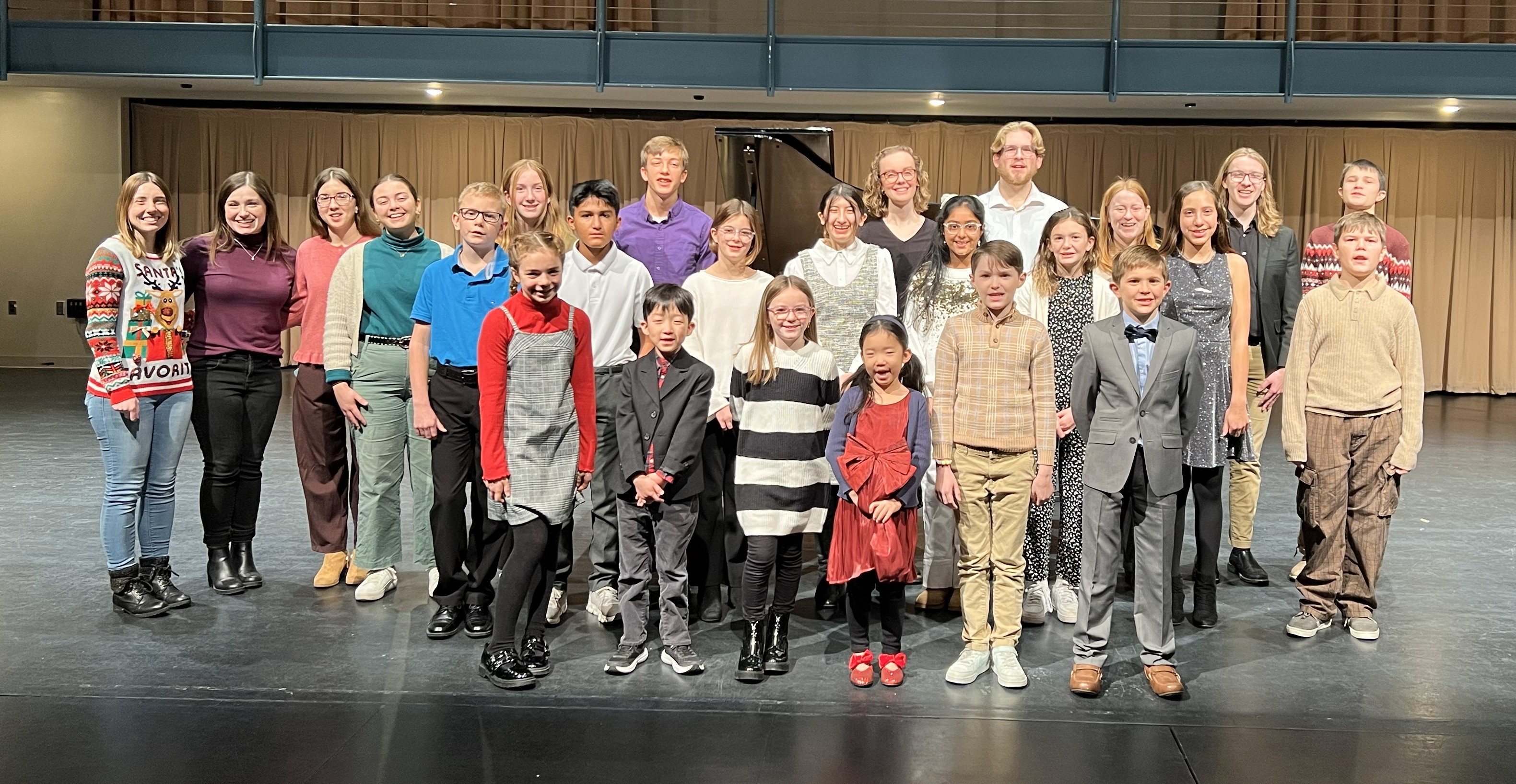 Students and teachers posing together after a recital performance.