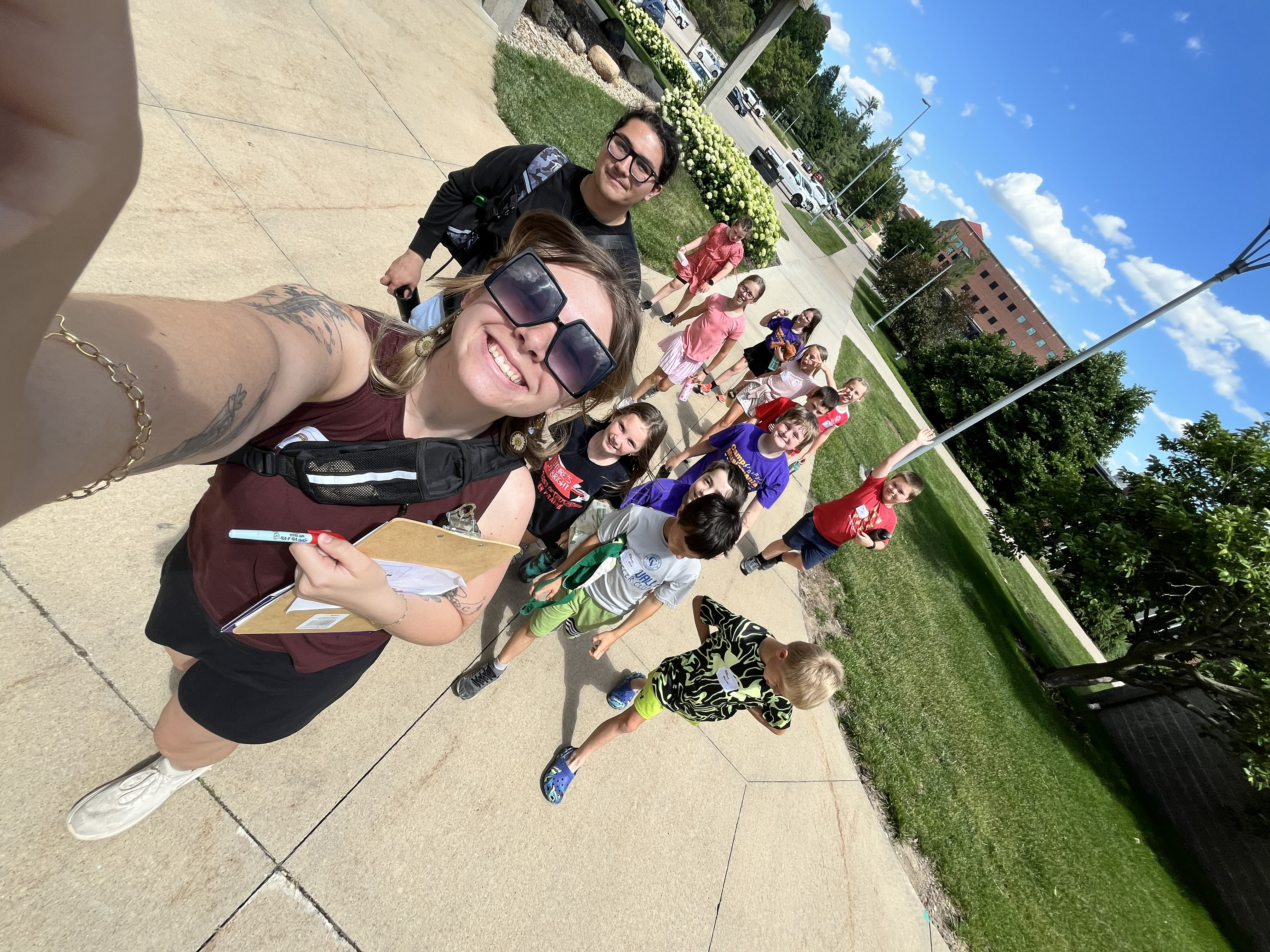 "selfie" view of student teacher and group of kids walking outside