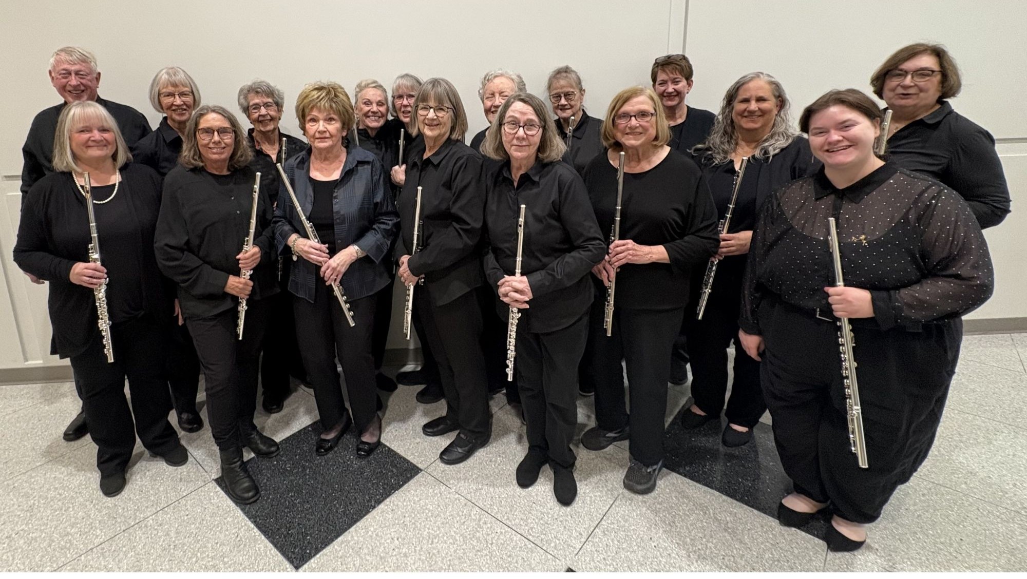 New Horizons Flute section posing with student teacher