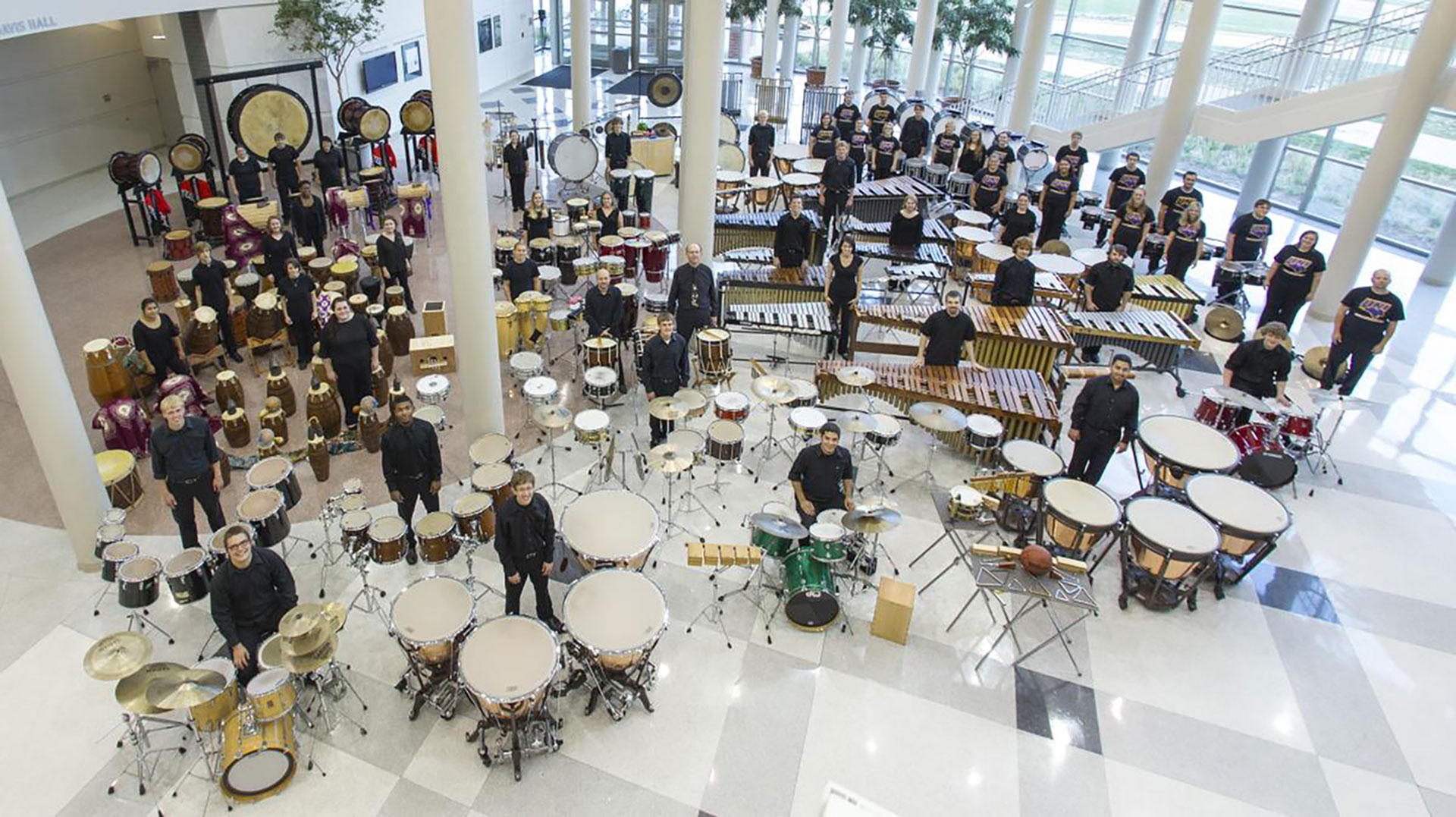 Percussion players on the floor of Ghallager Bluedorn Center.