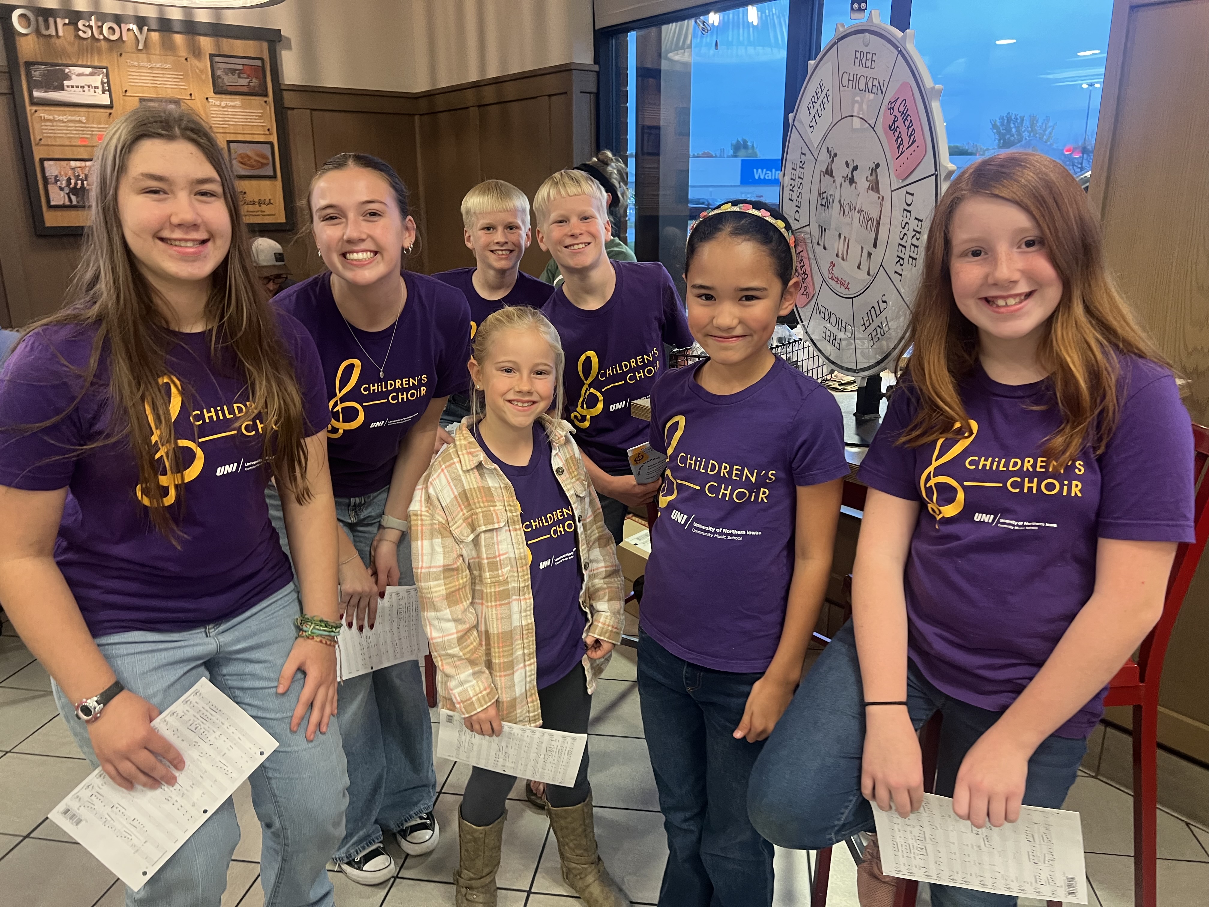 group of children's choir members, wearing choir shirts at chik-fil-a fundraiser