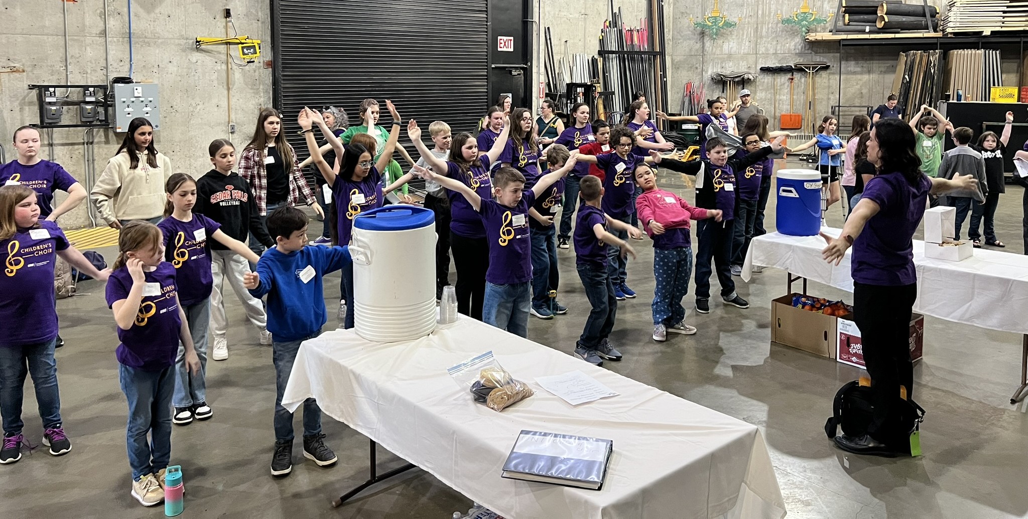 Warm-ups and stretching before rehearsing on stage at the Midwest Children's Choir Festival