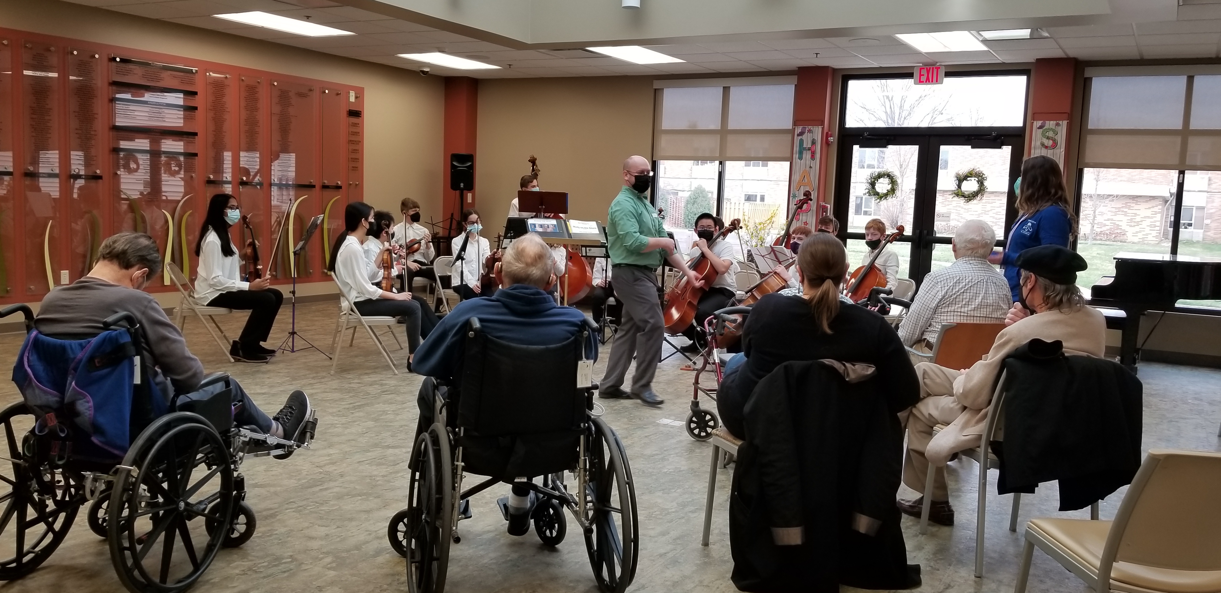 A middle school orchestra playing at a nursing facility