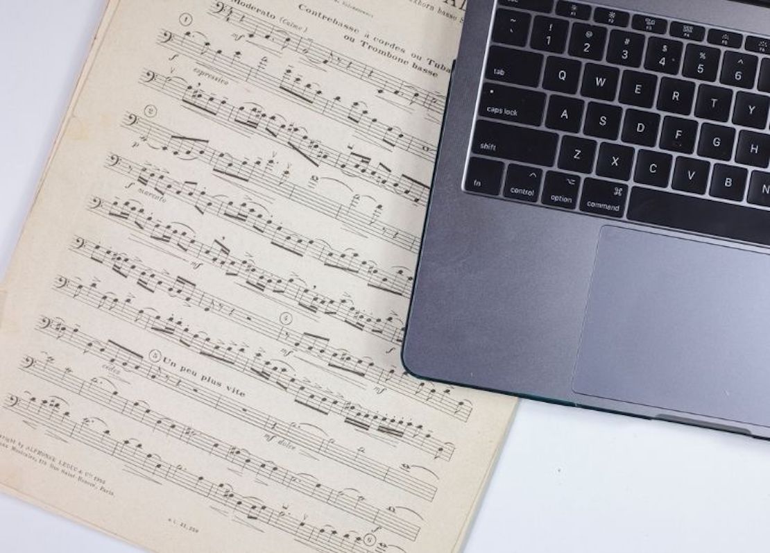 sheet music and a laptop