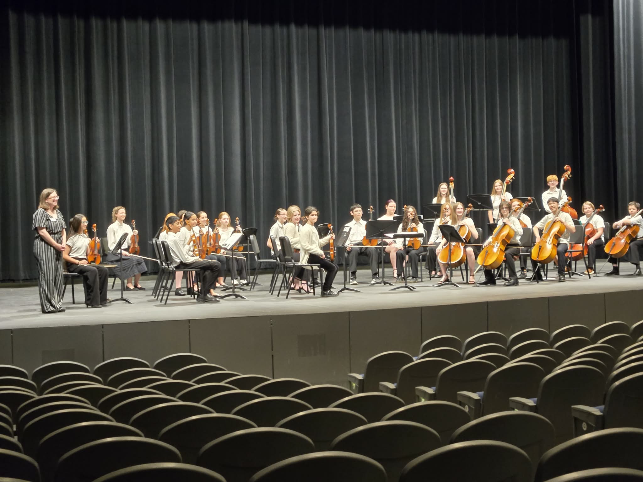 A middle school orchestra after their concert on tour