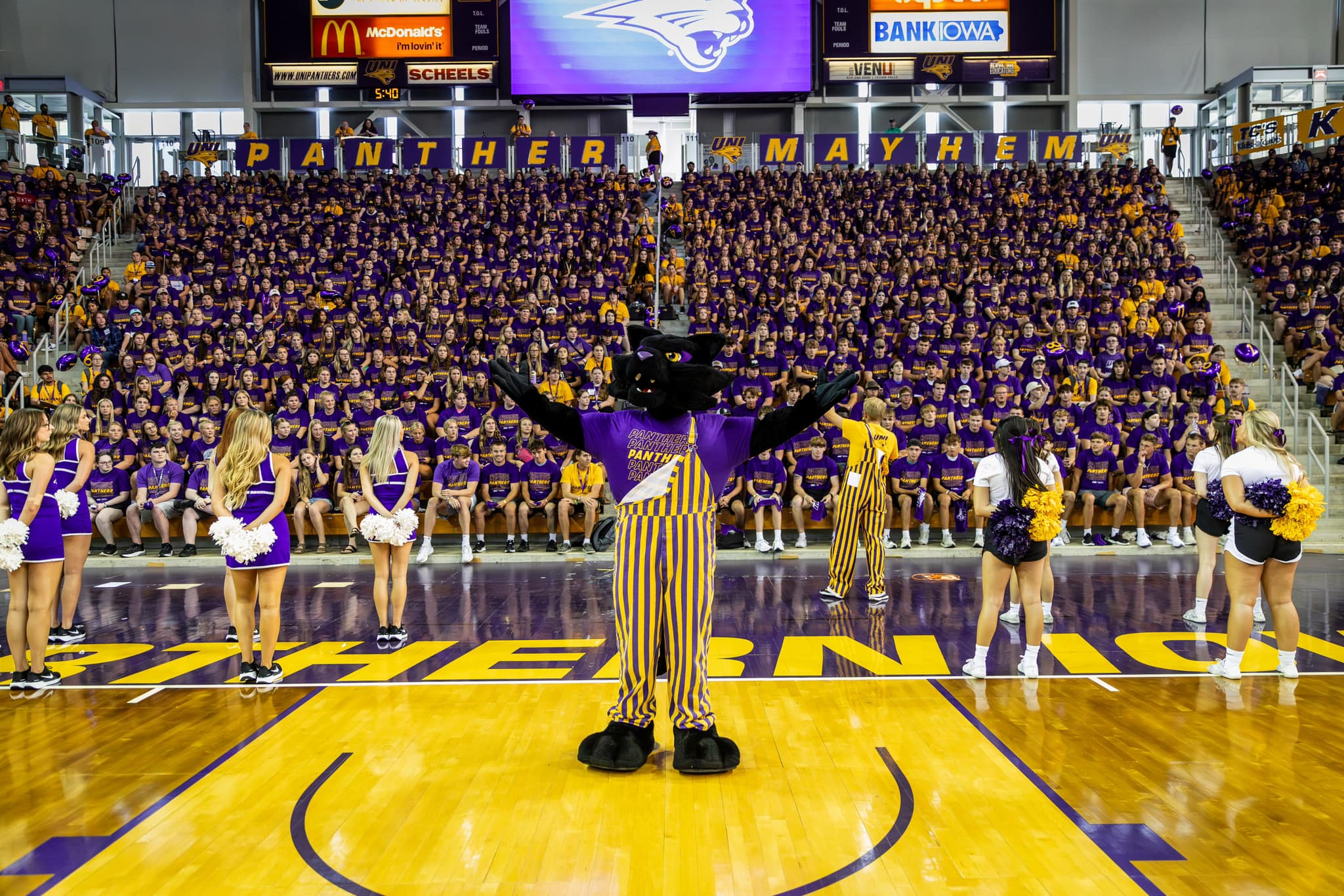 Cheer squad members and mascot TC encouraging the new student crowd at University of Northern Iowa