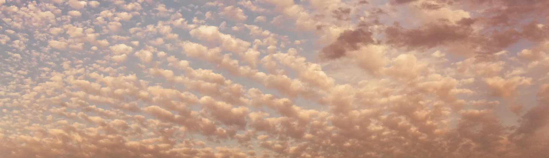 Image of clouds blanketing the sky, brighter and lighter to the left, growing darker and heavier to the right